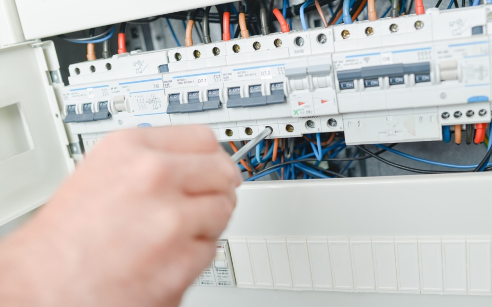 Electrician repairing a fuse